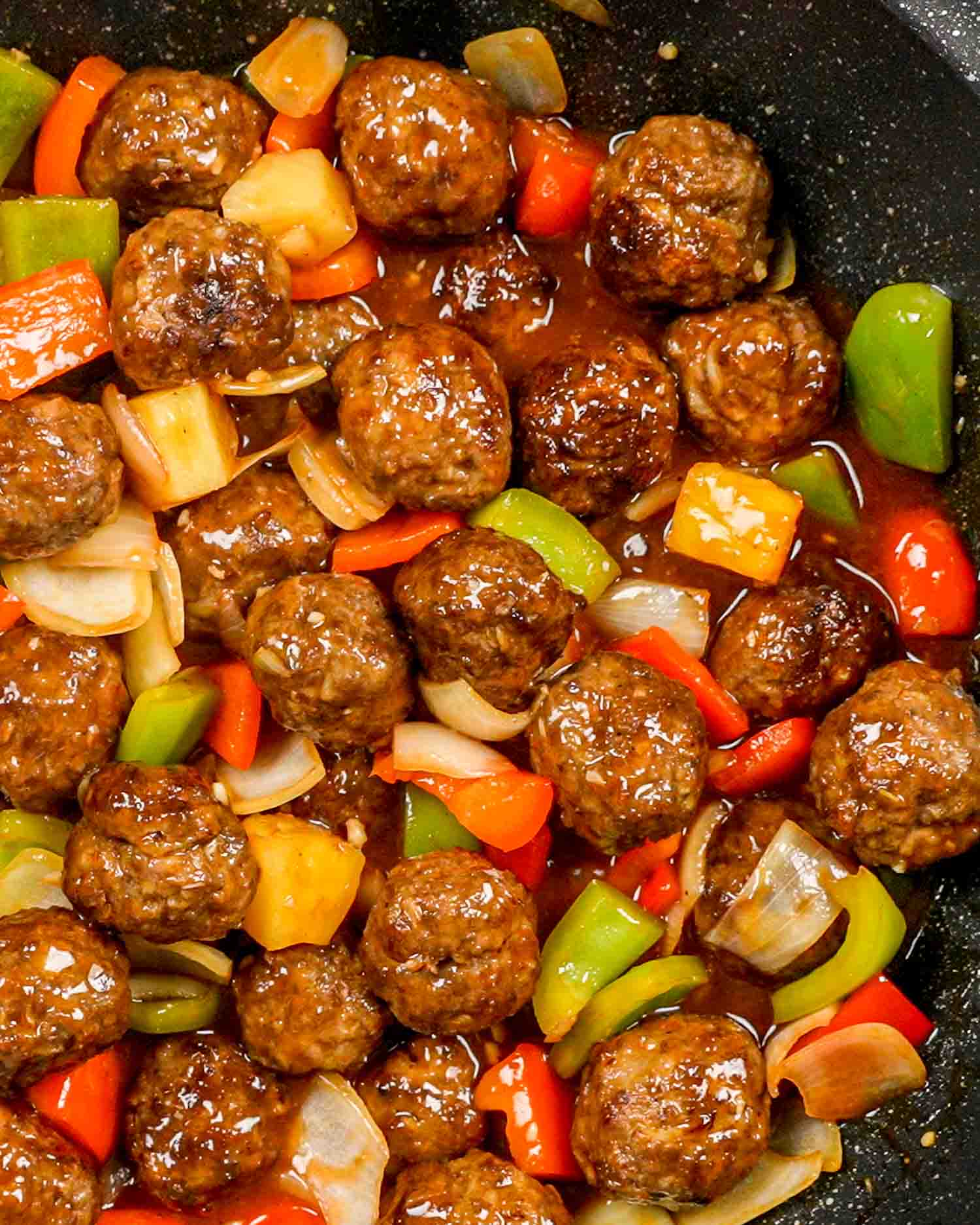 sweet and sour meatballs in a wok.