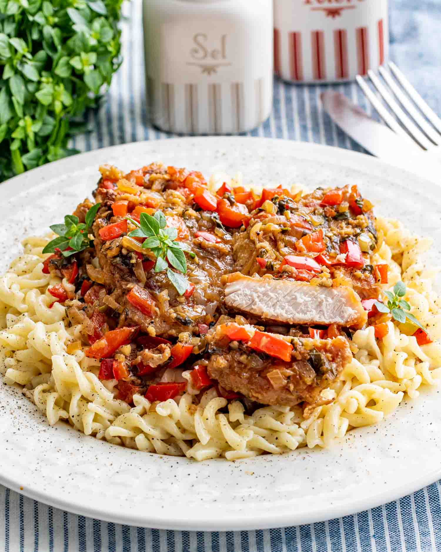 a plate full of creamy noodles and a balsamic pork scallopini.