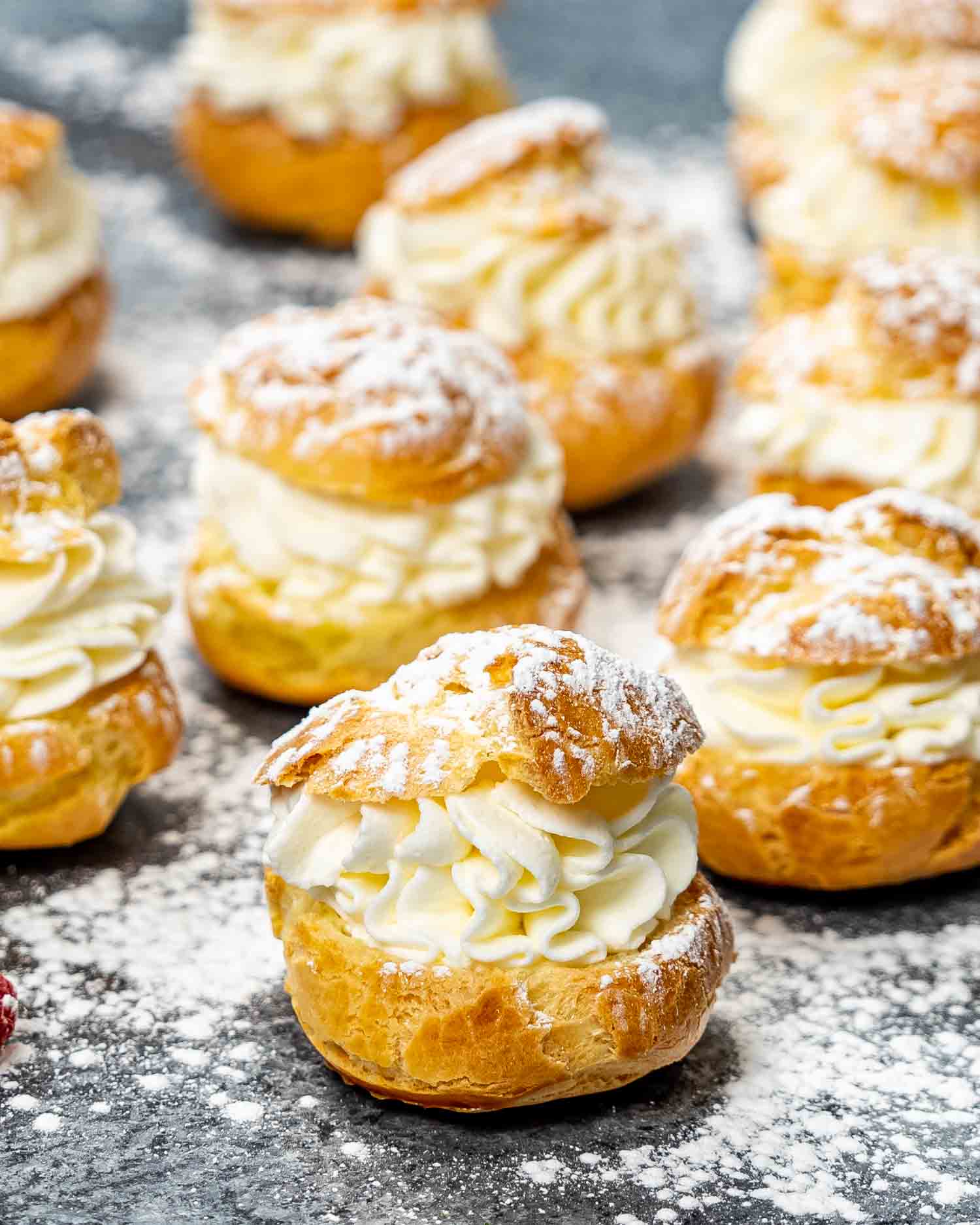 puffs (choux pastry) filled with whipped cream on a platter.