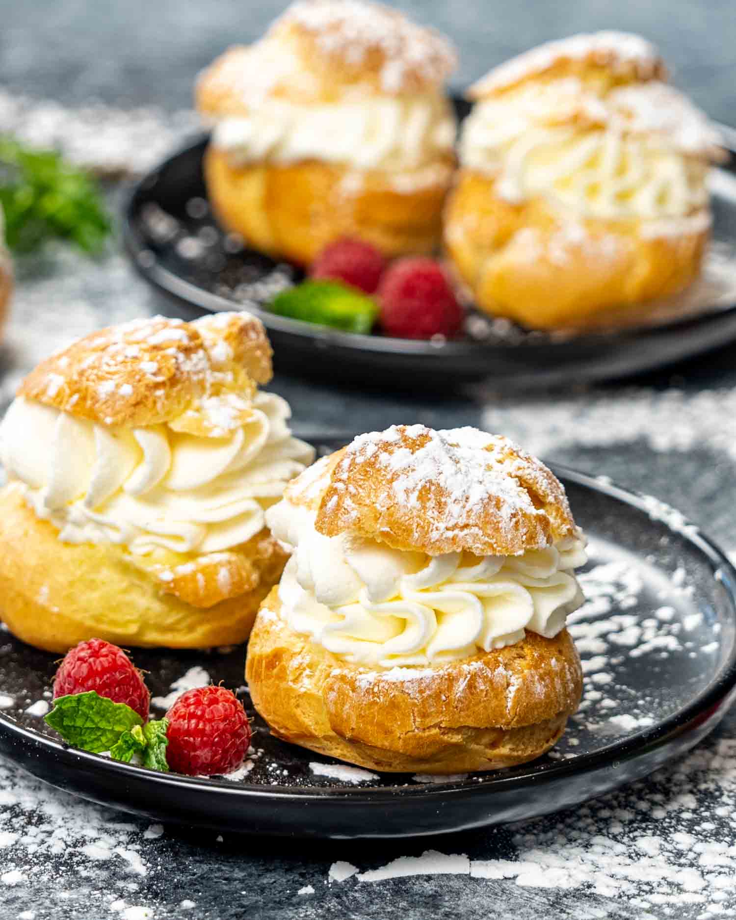 puffs (choux pastry) filled with whipped cream on a platter.