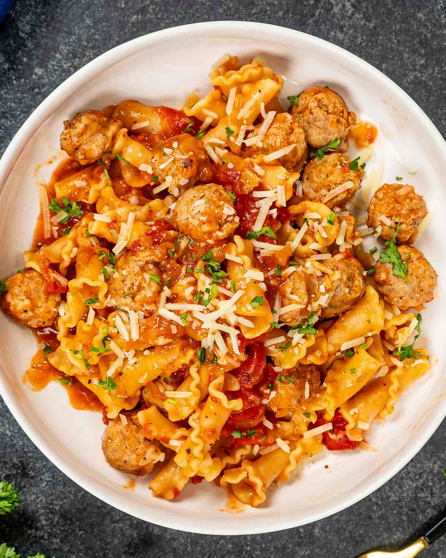 a serving of one pot sausage pasta in a white bowl.