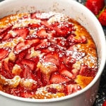 a freshly baked strawberry cobbler in a oval pan.