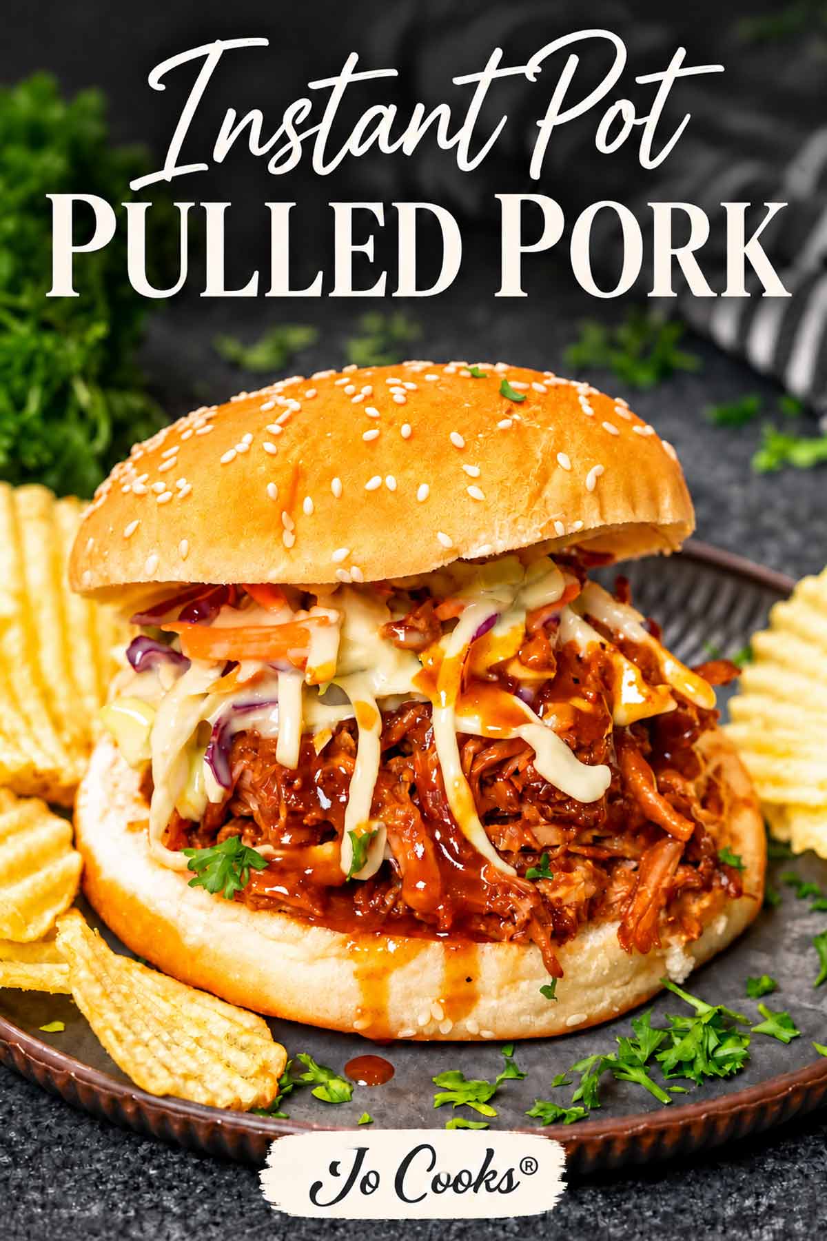 nstant Pot pulled pork sandwich topped with coleslaw, served with potato chips, with recipe title and Jo Cooks® logo.