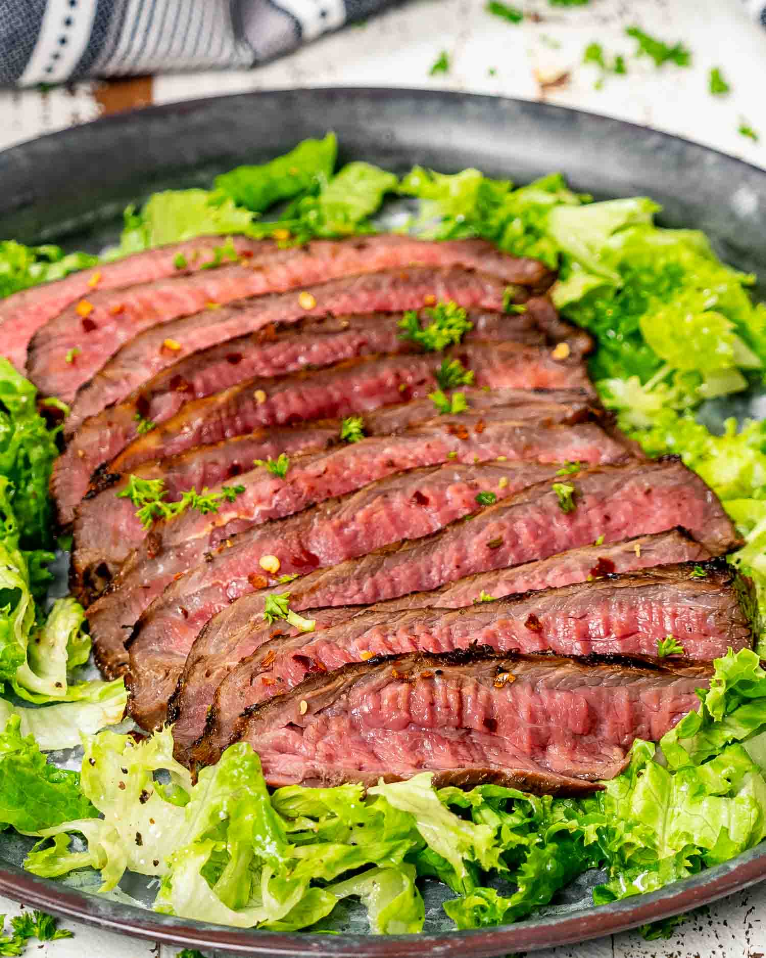 london broil all sliced up on a bed of lettuce.