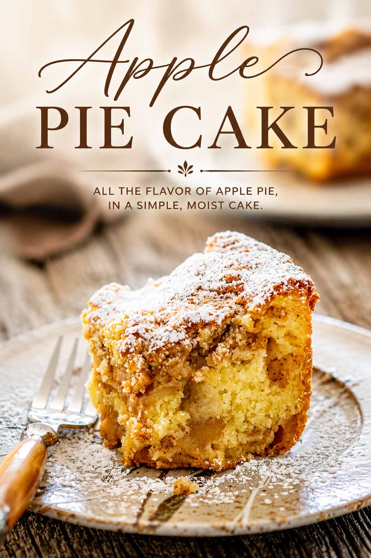 Slice of apple pie cake packed with cinnamon apples, dusted with powdered sugar, with elegant recipe title text above.