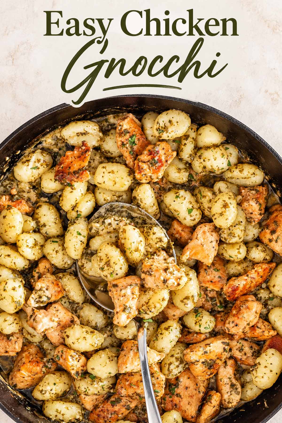 Overhead skillet of garlic butter chicken and tender gnocchi with herbs beneath an elegant Easy Chicken Gnocchi title.