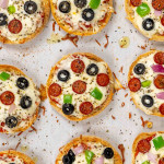 english muffin pizzas on a baking sheet lined with parchment paper.