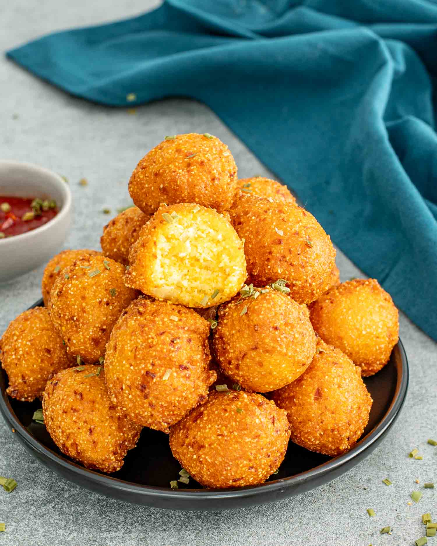 a plate filled with freshly made hush puppies.