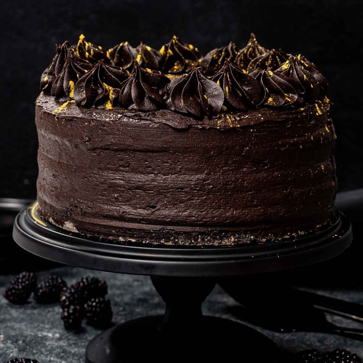 a black velvet cake on a black cake platter.