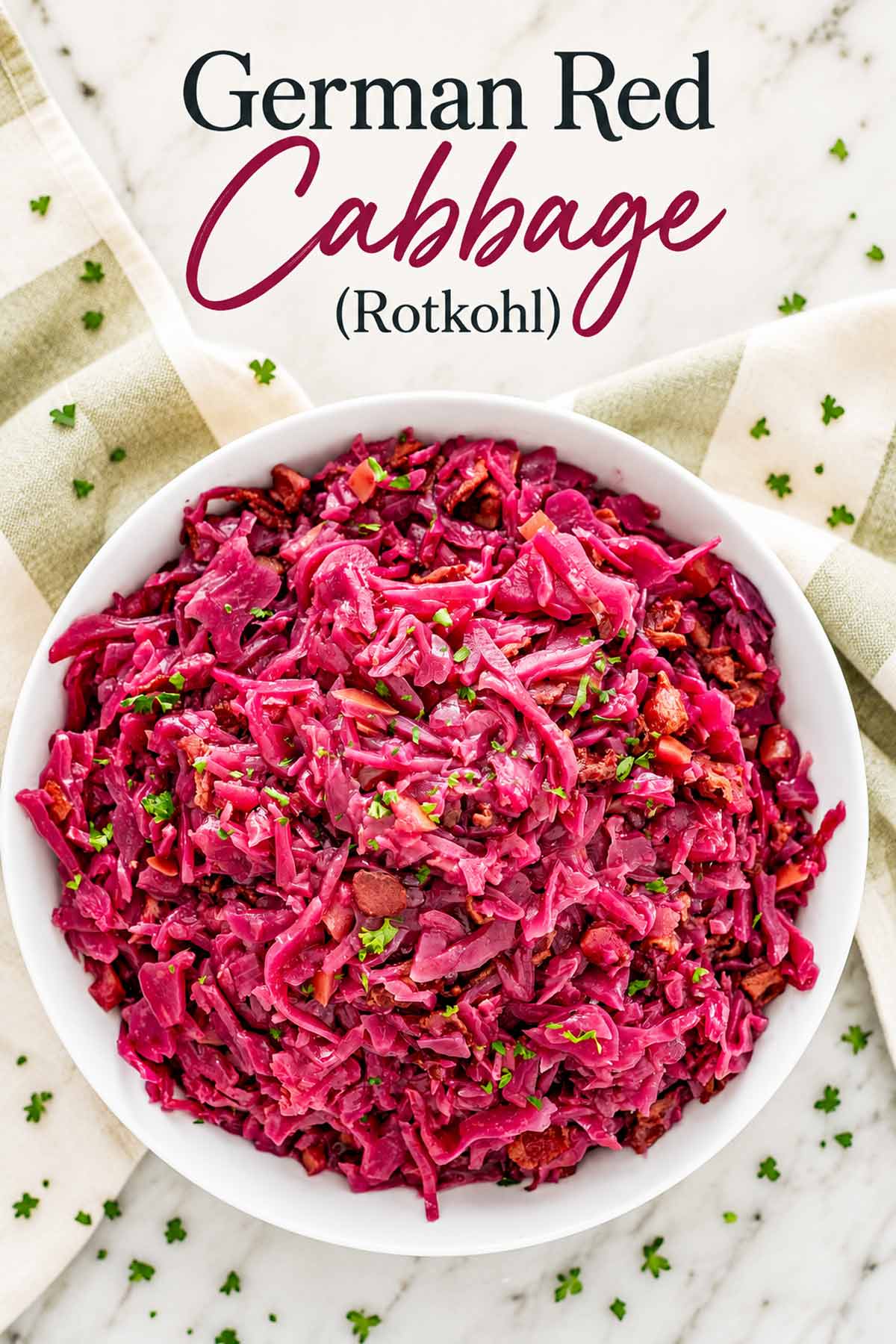 Overhead view of German red cabbage in a white bowl, sprinkled with parsley, with “German Red Cabbage (Rotkohl)” above.