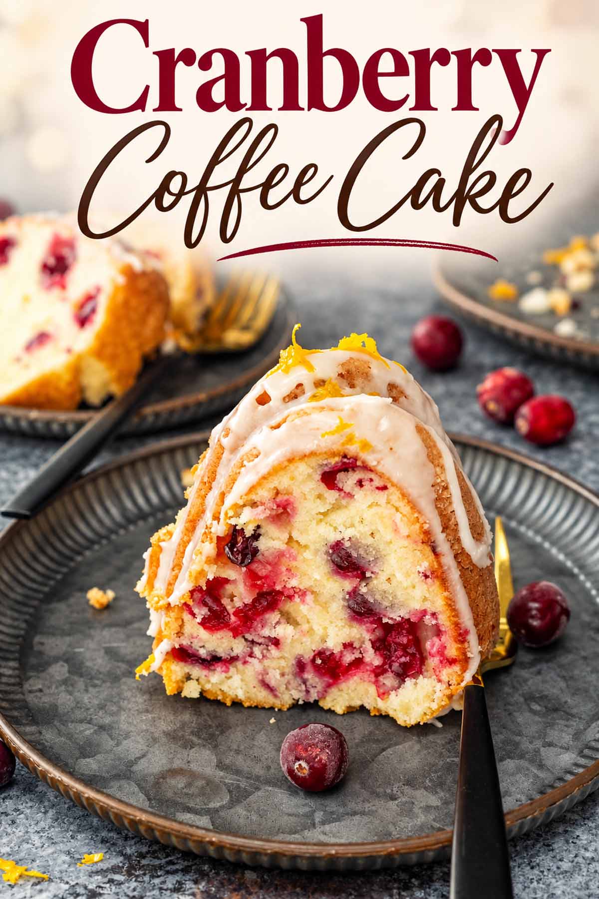 Glazed cranberry coffee cake slice on a dark plate, topped with orange zest and surrounded by fresh cranberries.