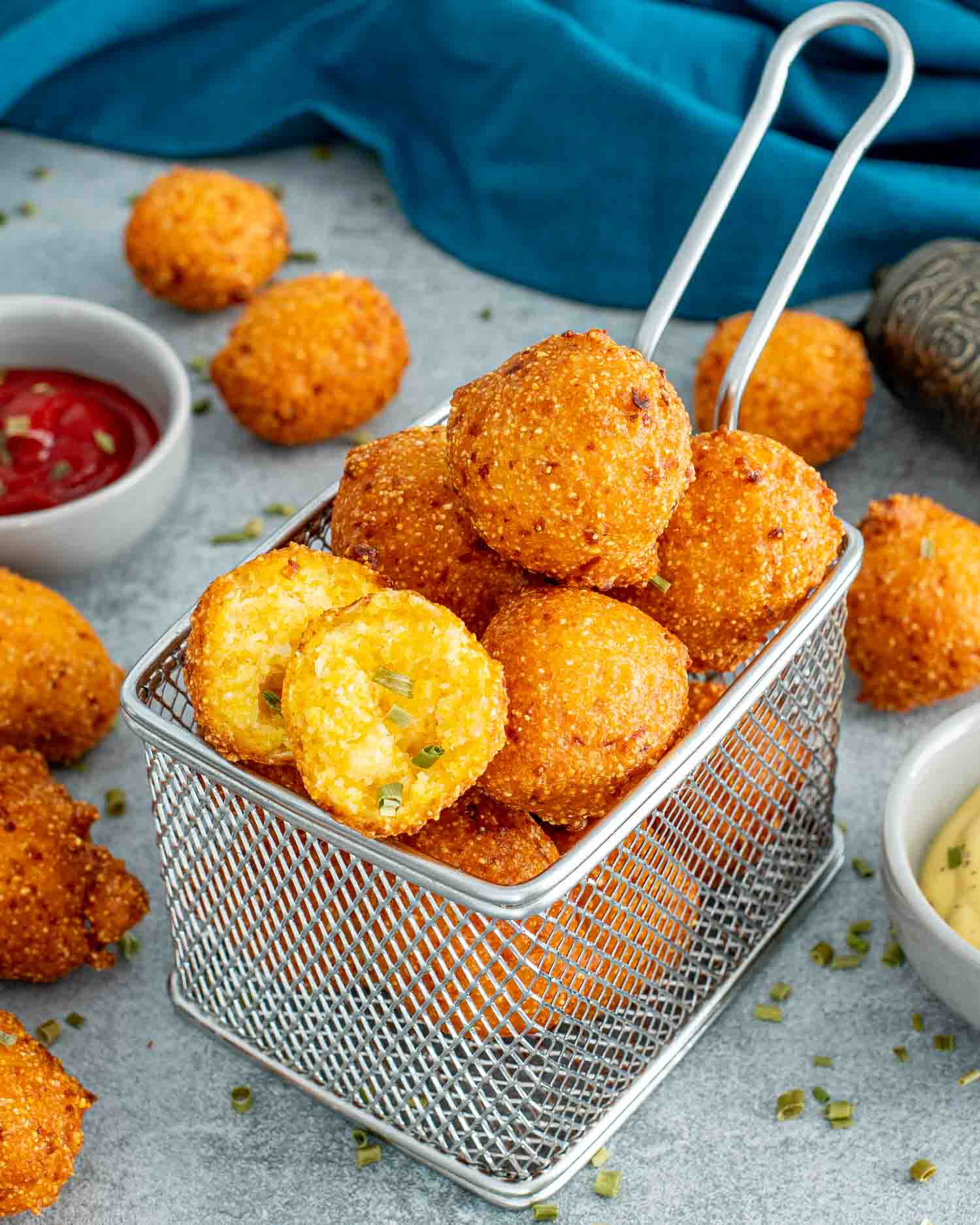 a basket full of freshly made hush puppies.