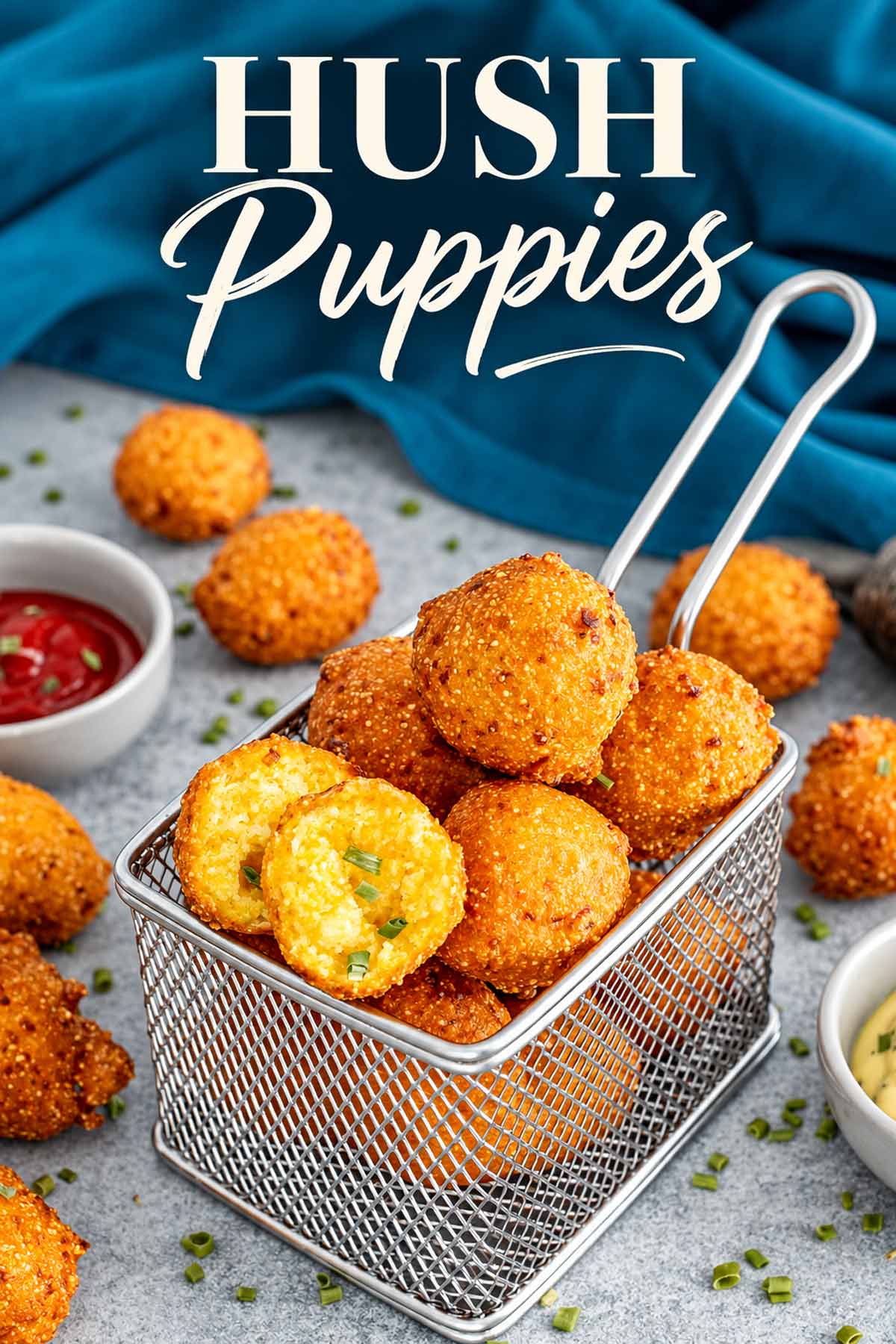 Crispy golden hush puppies served in a metal fryer basket with dipping sauces and the recipe title overhead.