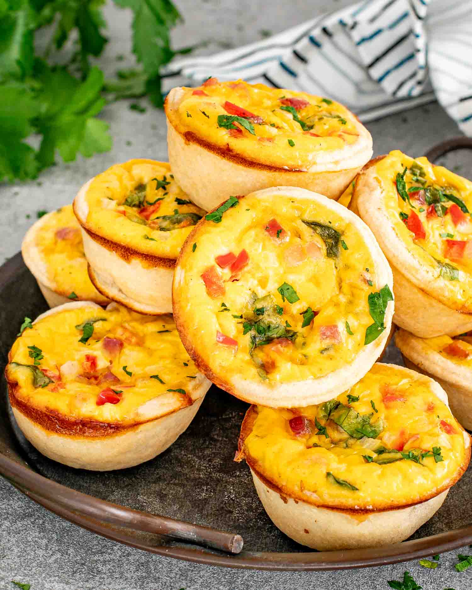 a plate full of freshly baked mini quiche.
