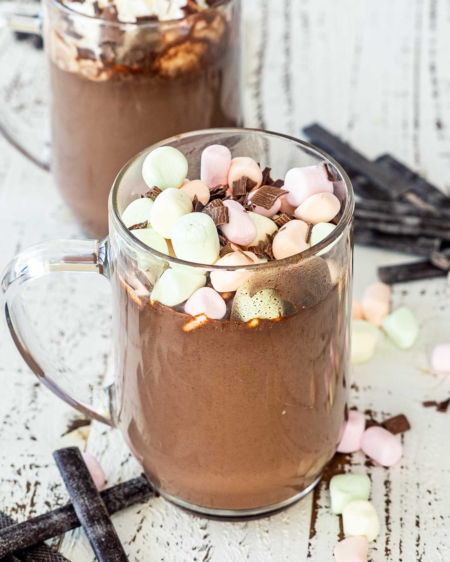 a hot chocolate in a mug topped with marshmallows.