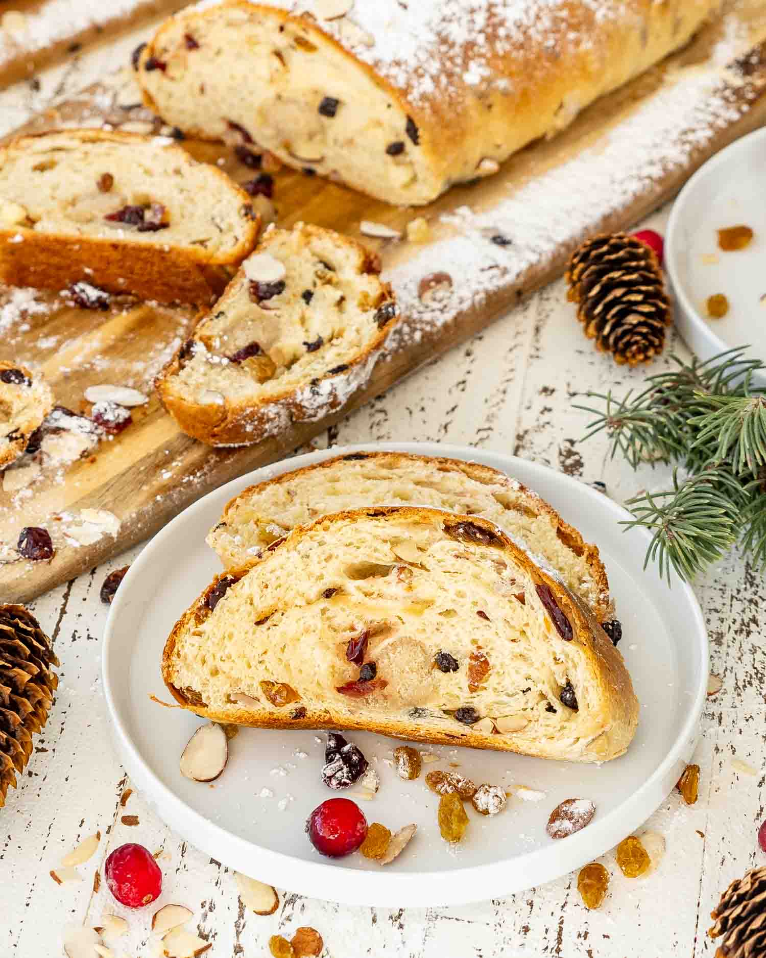 two slices of stollen on a white plate.