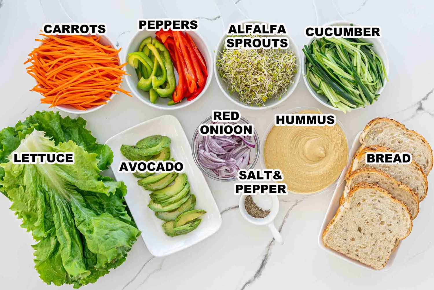 ingredients needed to make veggie and hummus sandwich.