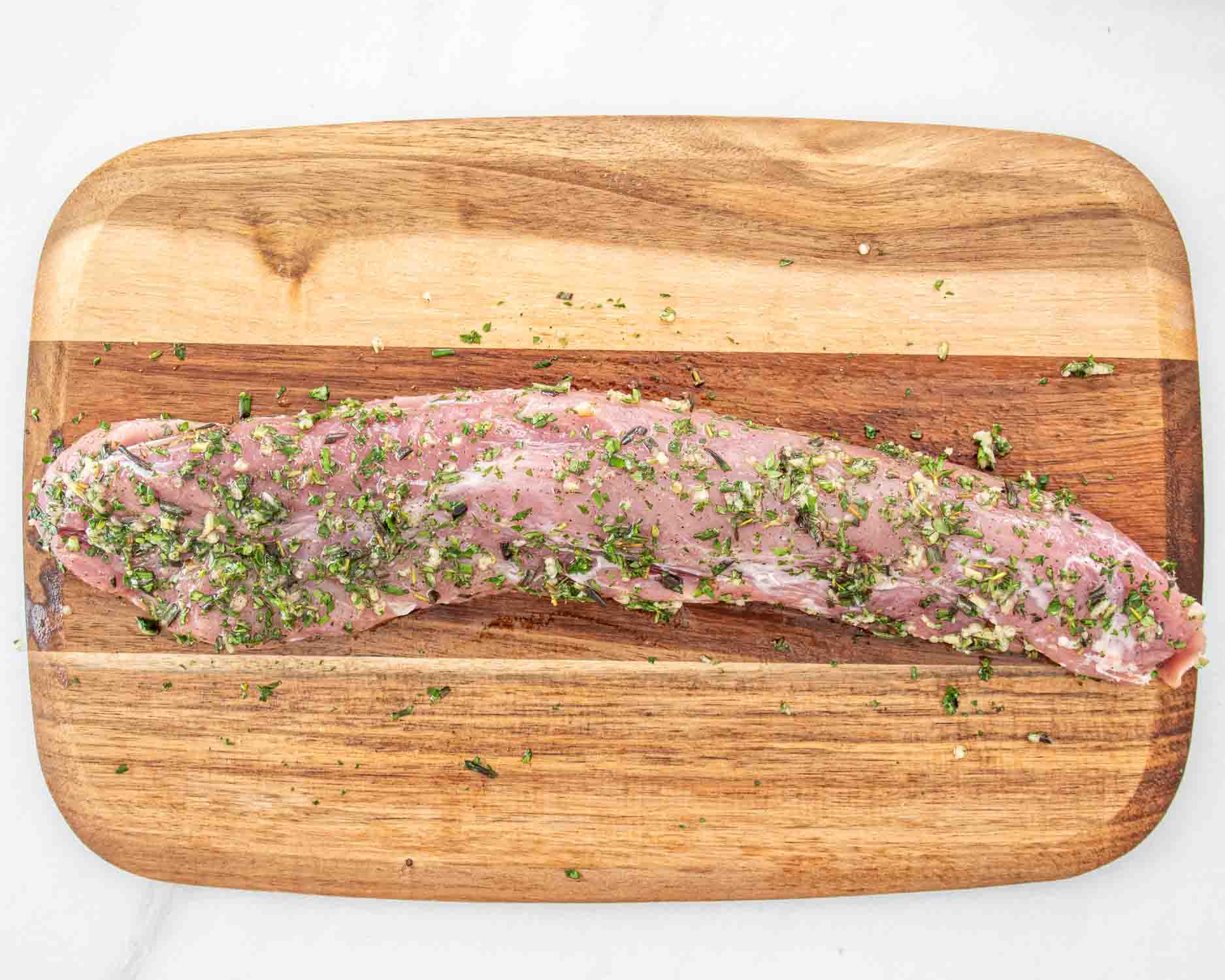 process shots showing how to make herb crusted pork tenderloin.