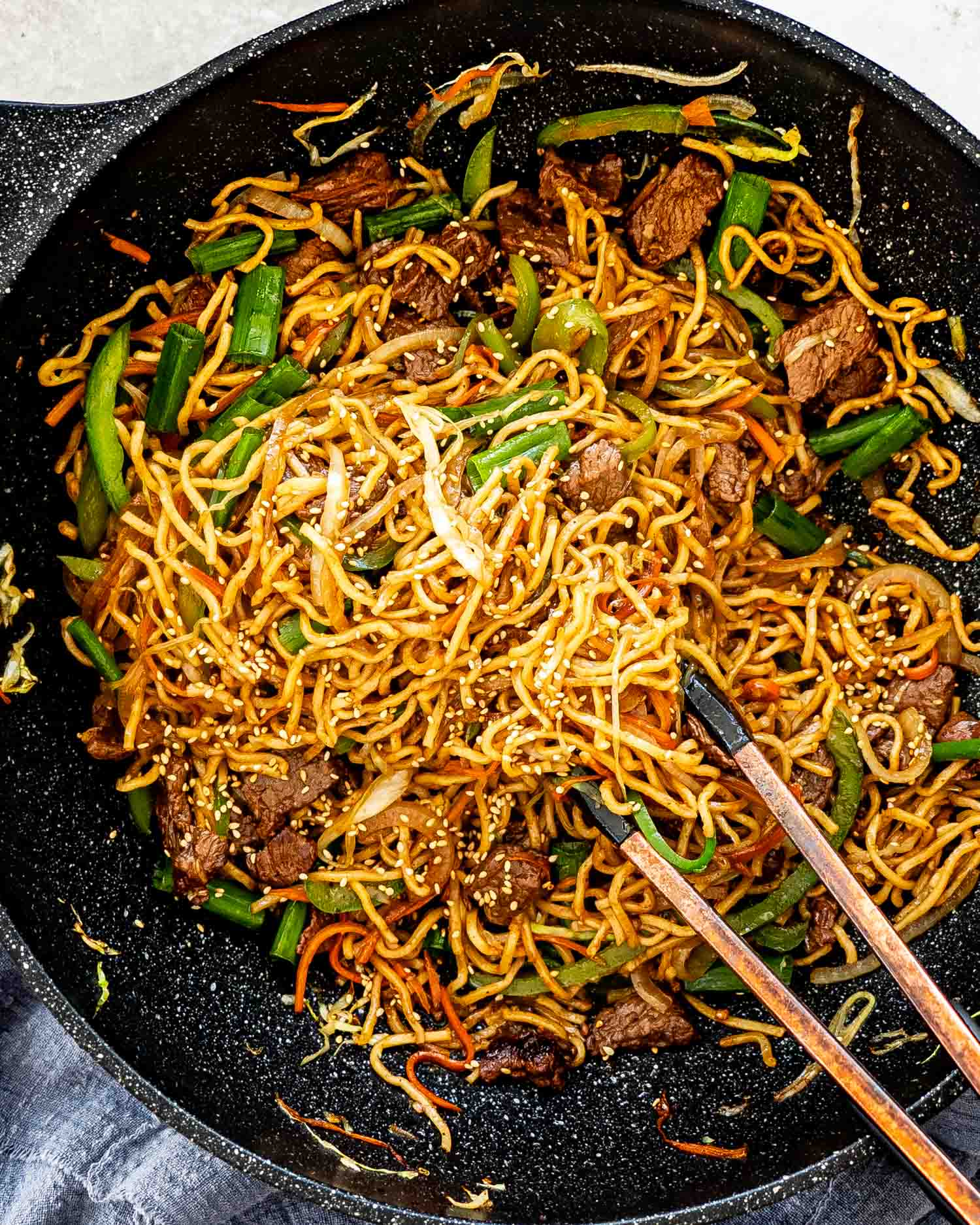 freshly made beef chow mein in a wok.
