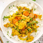 a serving of chinese chicken curry on a bed of jasmine rice.