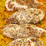 freshly baked parmesan herb chicken in a casserole dish.