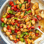 pepper chicken stir fry in a stainless steel skillet.