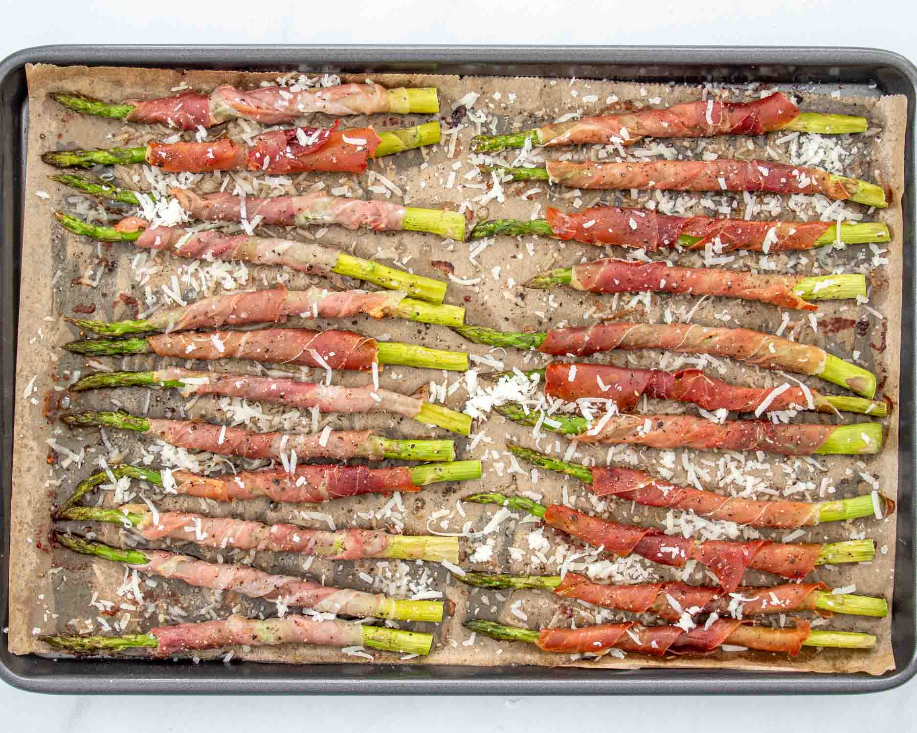 process shots showing how to make prosciutto wrapped asparagus.