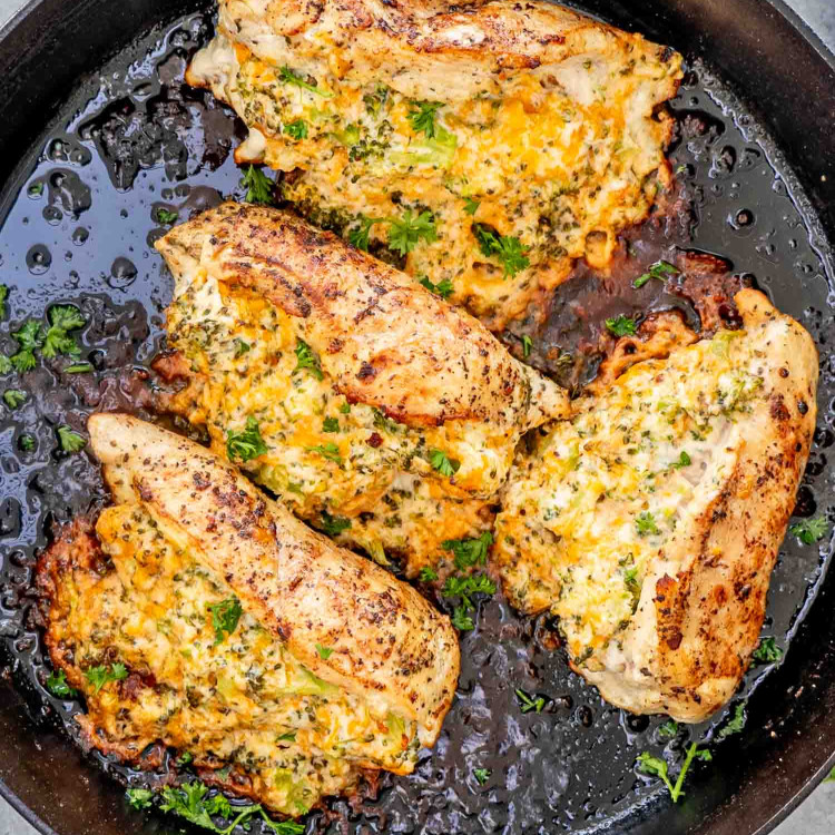 broccoli and cheddar stuffed chicken breast in a cast iron skillet.