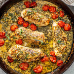 creamy pesto chicken in a cast iron skillet.