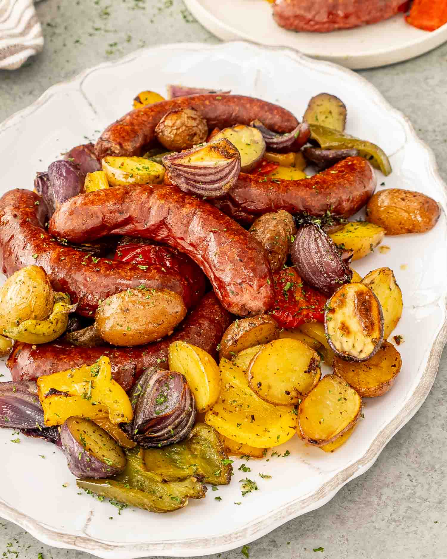 a plate full of sausage and potato sheet pan dinner.