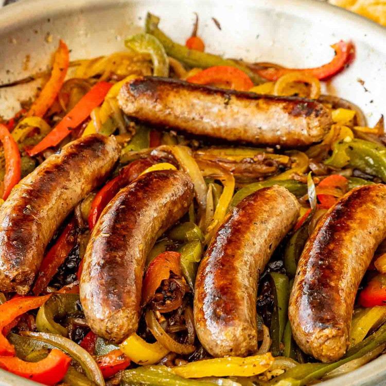sausage peppers and onions in a skillet.
