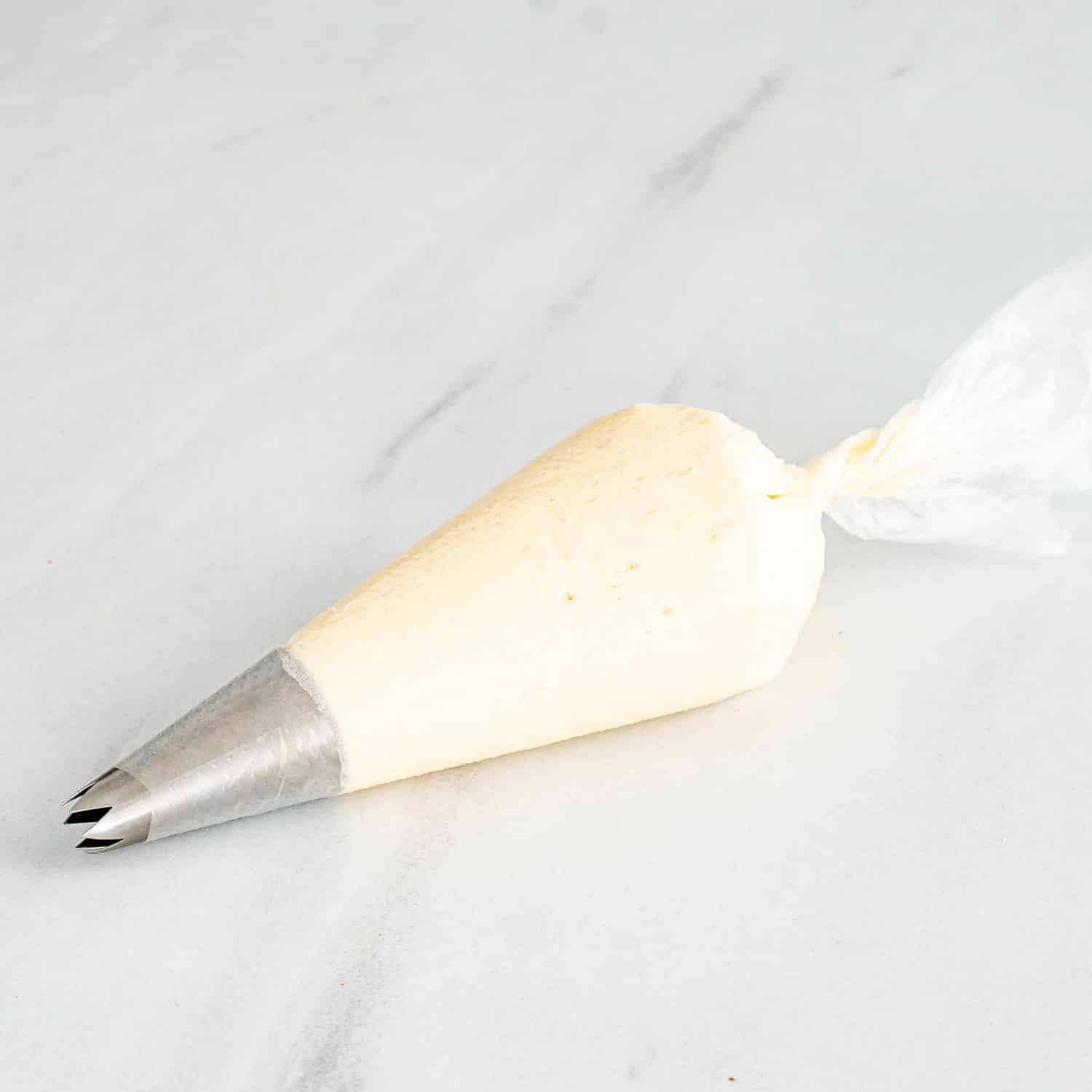 vanilla frosting in a piping bag.