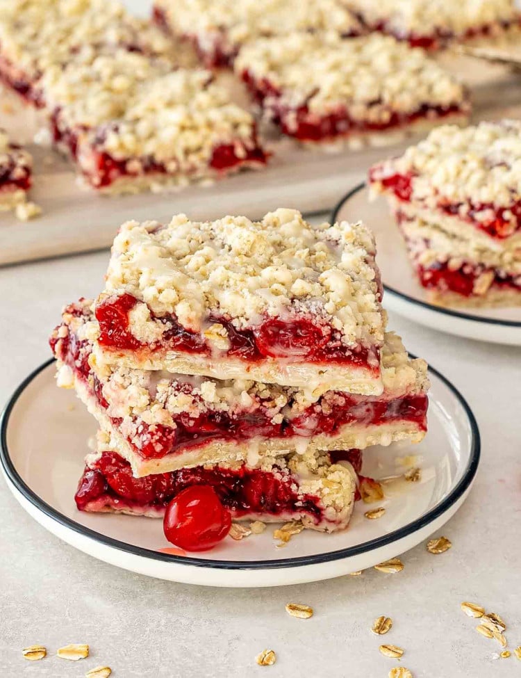 two cherry pie bars on a white plate.