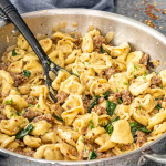 a skillet full of creamy sausage tortellini.