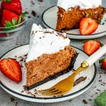 a slice of French silk pie on a dessert plate garnished with chocolate shavings.