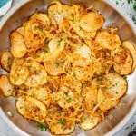 lyonnaise potatoes in a stainless steel skillet.
