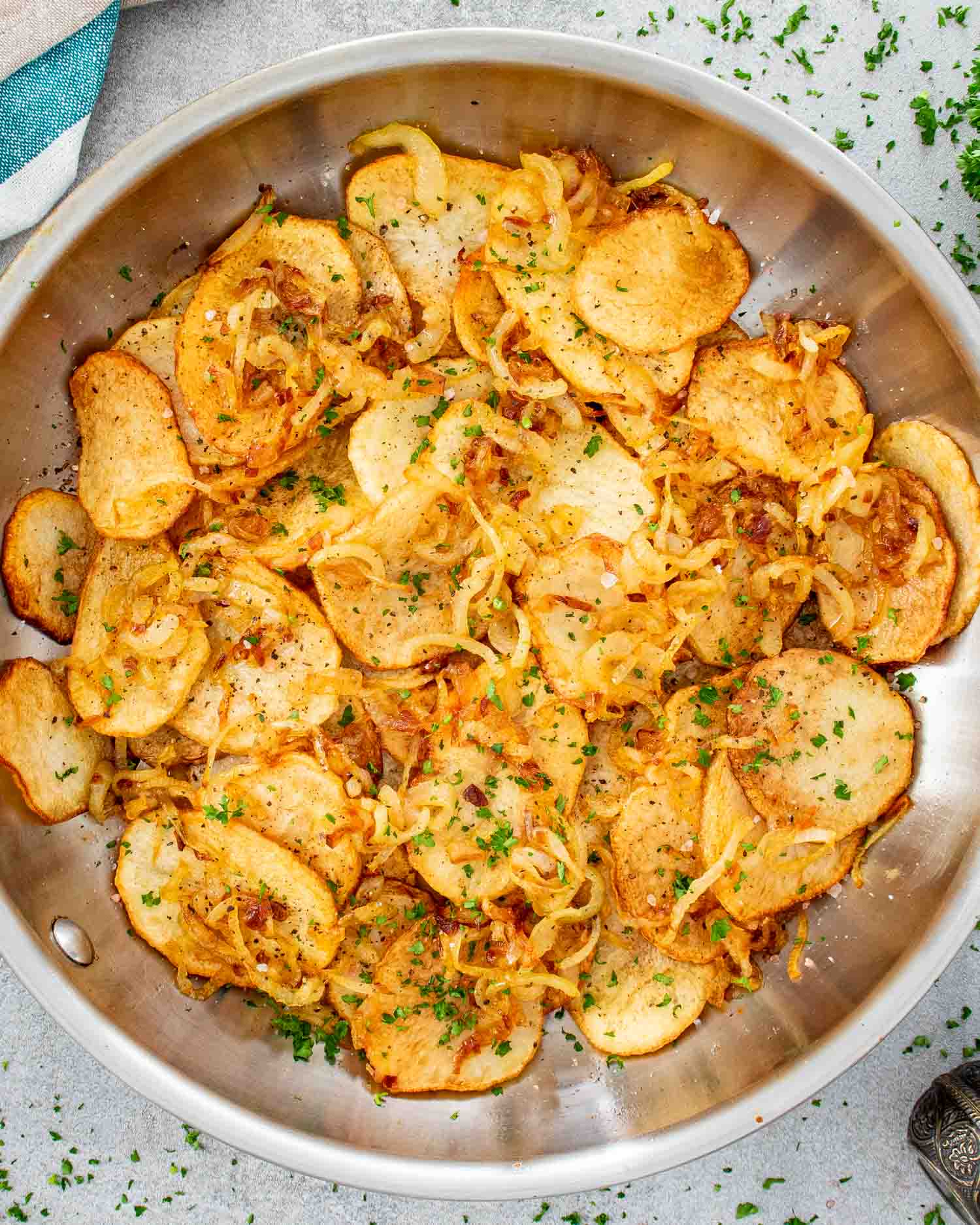 lyonnaise potatoes in a stainless steel skillet.