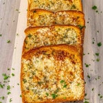 fresh out of the oven texas toast on a cutting board.
