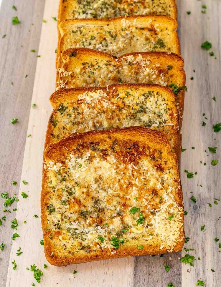 fresh out of the oven texas toast on a cutting board.