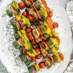 grilled veggie skewers fresh off the grill on a platter.