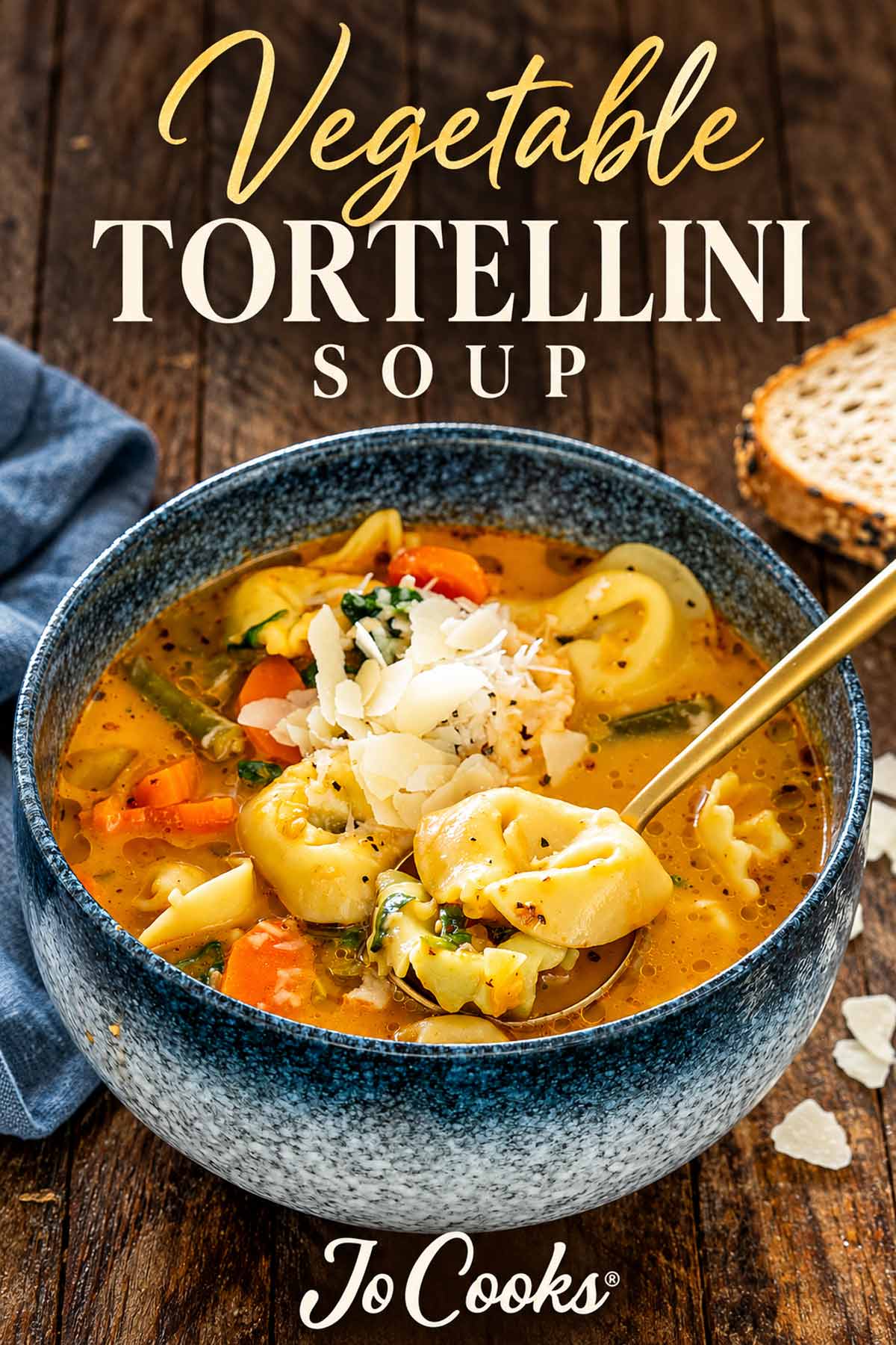 Parmesan-topped vegetable tortellini soup in a blue bowl beneath gold and ivory recipe lettering, with the Jo Cooks logo.