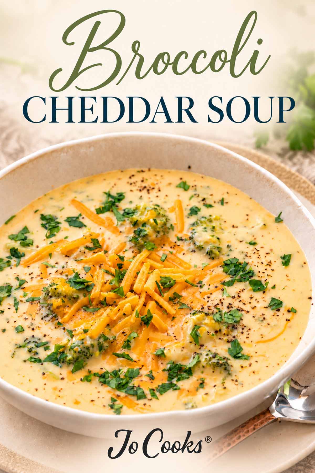 Bowl of broccoli cheddar soup garnished with cheese, parsley, and black pepper, with recipe title and Jo Cooks logo.