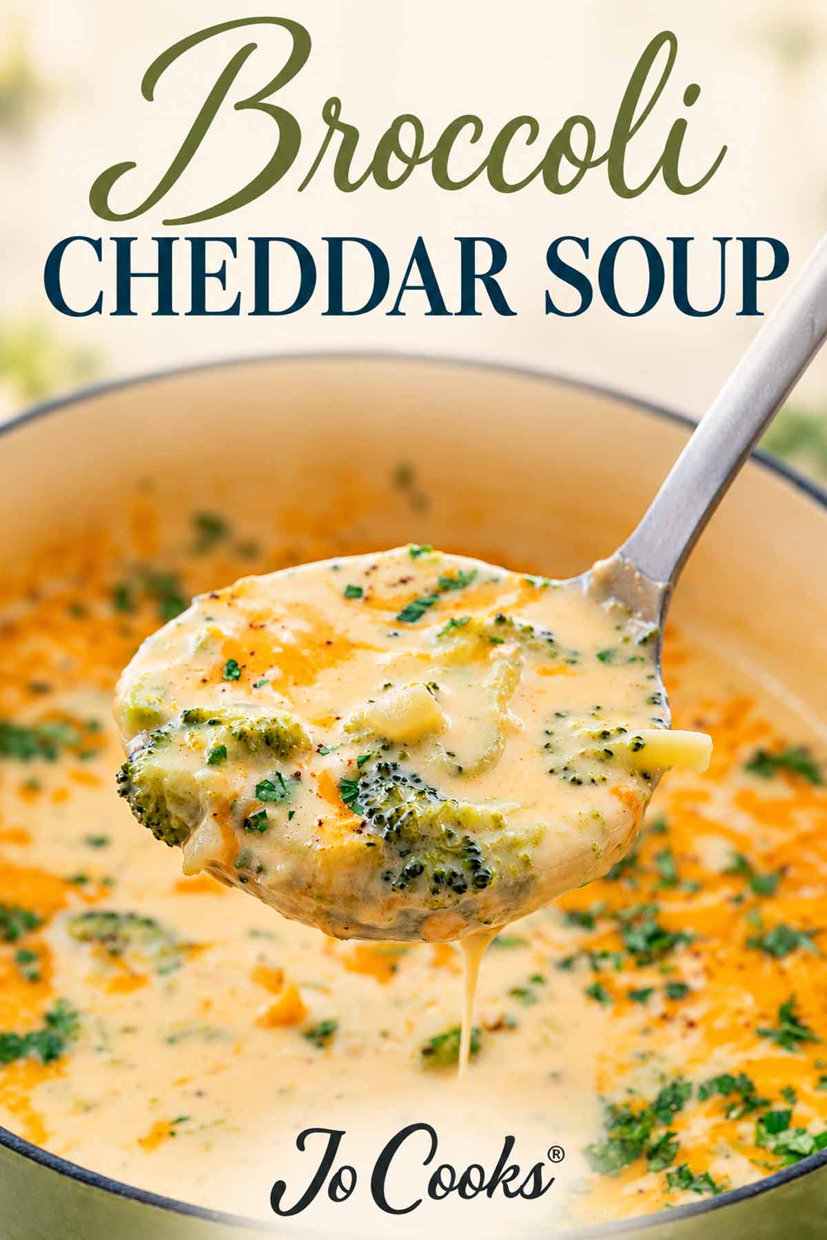 Raised ladle of creamy broccoli cheddar soup dripping into a pot, with recipe title above and Jo Cooks logo below.