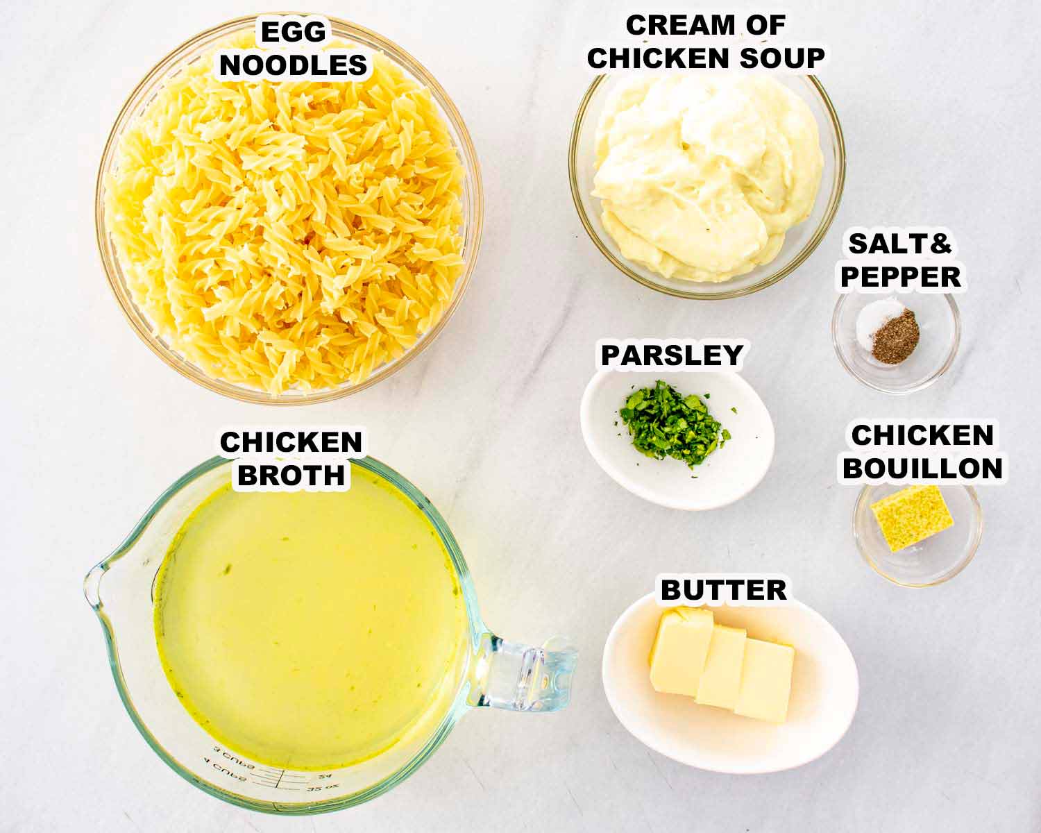 Egg noodles, chicken broth, cream of chicken soup, butter, parsley, and bouillon measured out for making creamy cafeteria noodles.