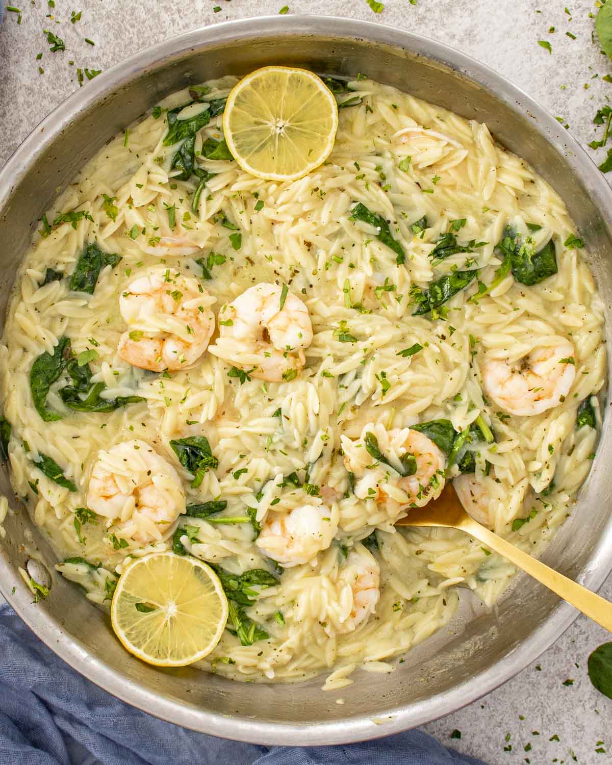 Finished lemon garlic shrimp orzo in skillet, creamy and bright with shrimp, spinach, Parmesan, and fresh lemon.