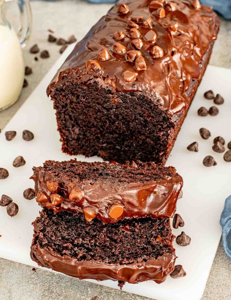 Cut Double Chocolate Loaf Cake with ganache frosting revealing dense, moist chocolate interior and melted chocolate chips.