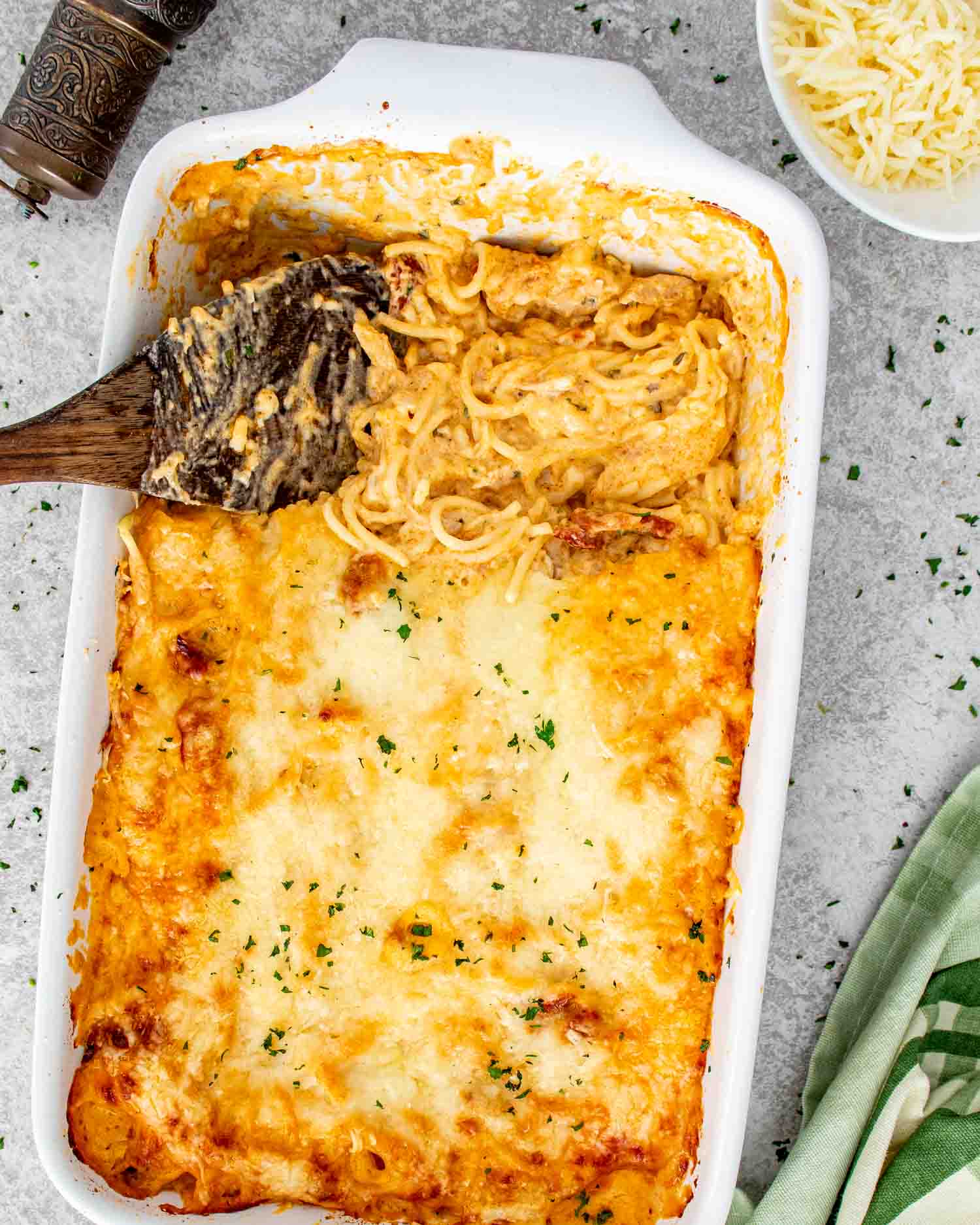 Marry me baked spaghetti fresh out of the oven with golden melted cheese on top.
