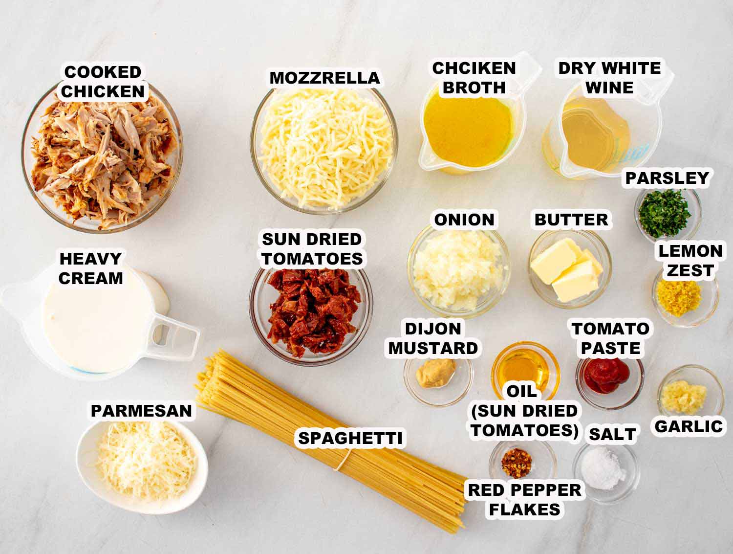 Ingredients for marry me baked spaghetti including chicken, spaghetti, cream, sun dried tomatoes and cheese.