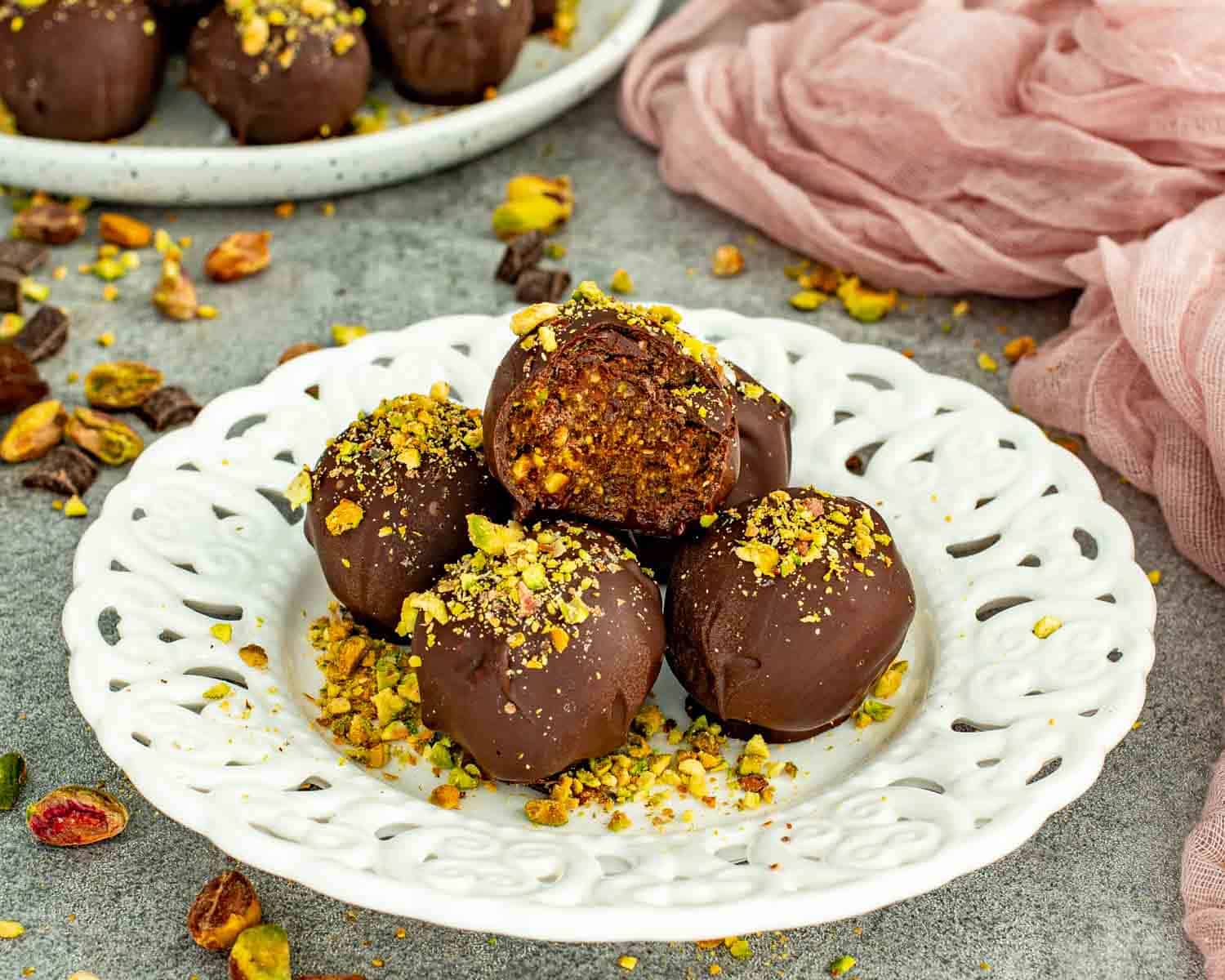 Inside of pistachio date chocolate balls showing the soft date filling.