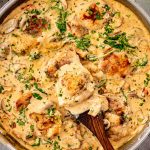 One pan creamy mushroom and sun dried tomato chicken with golden chicken thighs simmered in rich sauce with spinach and mushrooms.